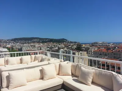 a white couch sitting on top of a balcony at Splendid Hotel & Spa Nice in Nice