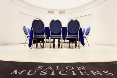 a row of blue chairs in a room with a table at Splendid Hotel & Spa Nice in Nice