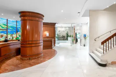 a hallway with a large wooden column in a building at Splendid Hotel & Spa Nice in Nice