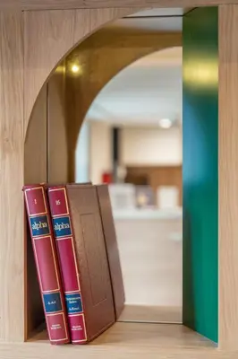 a row of books sitting on a shelf at Hotel Boréal Nice in Nice