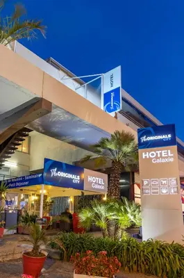 a hotel building with signs in front of it at The Originals City, Hôtel Galaxie, Nice Aéroport in Saint-Laurent-du-Var
