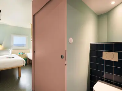a room with a bathroom with a door to a bedroom at Greet Hotel Nice Aéroport Promenade des Anglais in Nice