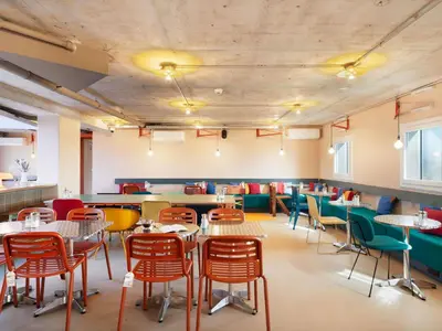 a restaurant with tables and chairs in a room at Greet Hotel Nice Aéroport Promenade des Anglais in Nice