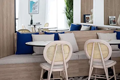 a kitchen with two black stools in front of a counter at Le Riviera Collection, Signature Collection by Best Western in Nice