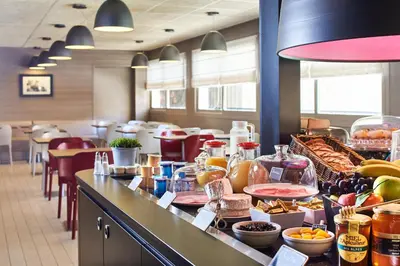 a buffet line in a restaurant with food on it at Campanile Hotel Nice Centre Acropolis in Nice
