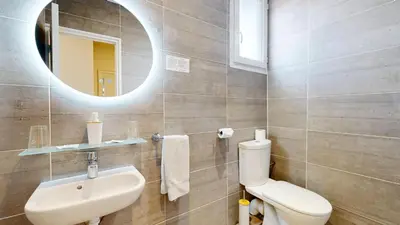 a bathroom with a sink and a toilet and a mirror at Hotel Solara in Nice