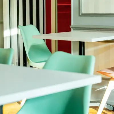 a group of chairs and tables in a room at Hotel Aria in Nice