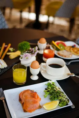 a table with plates of food and eggs and coffee at Hotel Carlton in Beaulieu-sur-Mer