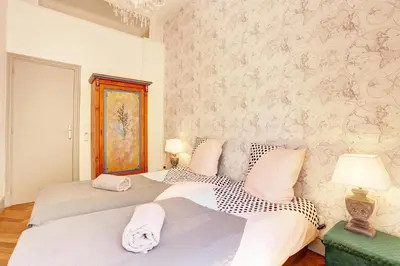 a bedroom with two beds and a wall at Le Philibert - SPLENDID, 6 BEDROOMS, 12P, NICE PORT, Air Cond in Nice