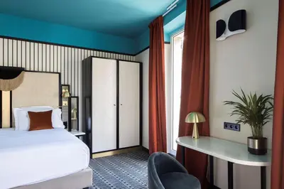 a bedroom with a bed and a desk and a chair at Best Western Premier Hotel Roosevelt in Nice