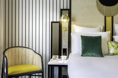 a bedroom with a bed and a chair and a table at Best Western Premier Hotel Roosevelt in Nice