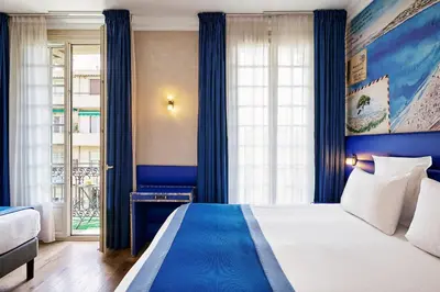 a hotel room with a bed and a window at Nice Excelsior Centre ville by HappyCulture in Nice