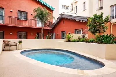 a swimming pool in front of a building at Nice Excelsior Centre ville by HappyCulture in Nice