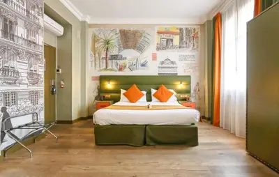 a bedroom with a large bed with orange pillows at Nice Excelsior Centre ville by HappyCulture in Nice
