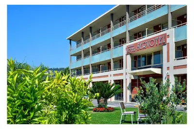 a hotel with chairs and plants in front of it at Servotel Saint-Vincent in Nice