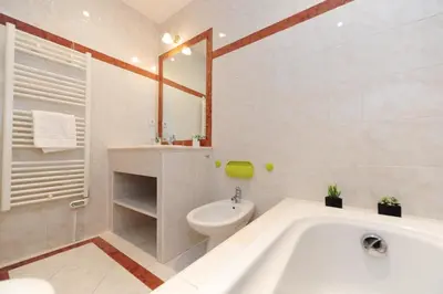 a bathroom with a tub and a toilet and a sink at Le Savoy Palace - Five Stars Holiday House in Nice