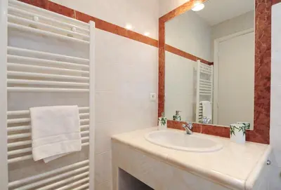 a bathroom with a sink and a mirror at Le Savoy Palace - Five Stars Holiday House in Nice