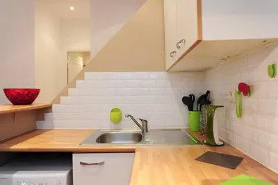 a kitchen with a sink and a staircase at Le Savoy Palace - Five Stars Holiday House in Nice