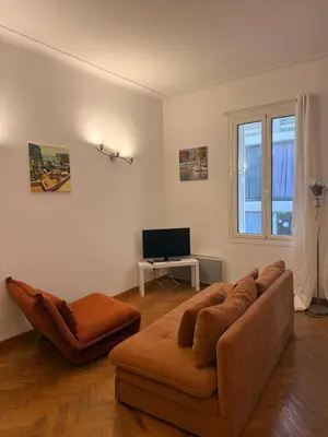 a living room with a couch and a television at Le Savoy Palace - Five Stars Holiday House in Nice
