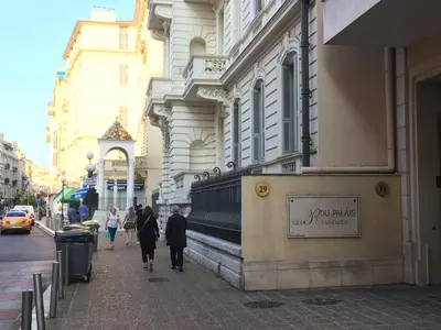a group of people walking down a city street at Quiet flat next to the beach in Nice
