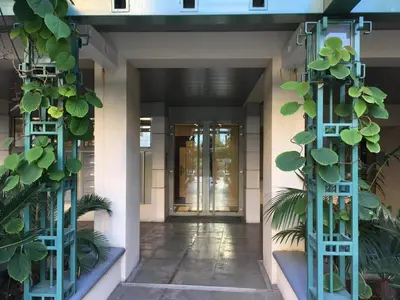 a hallway with plants in front of a building at Quiet flat next to the beach in Nice