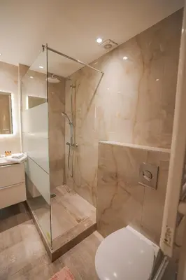 a bathroom with a glass shower and a toilet at AzurAppart Brilliant 2room, Nice Massena in Nice