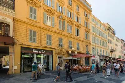 a group of people walking down a city street at AzurAppart Brilliant 2room, Nice Massena in Nice
