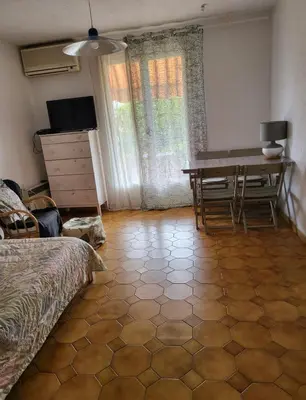 a bedroom with a desk and a table in a room at Studio in the center of Saint-Jean-cap-Ferrat in Saint-Jean-Cap-Ferrat