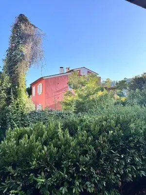 a red barn in the middle of a field at Studio in the center of Saint-Jean-cap-Ferrat in Saint-Jean-Cap-Ferrat