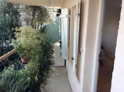 an open door of a house with a plant at Petite chambre indépendante avec sdb, clim et parking privé in Nice