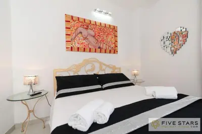 a bedroom with a bed with white towels on it at Mini Suite Bijou - Five Stars Holiday House in Nice