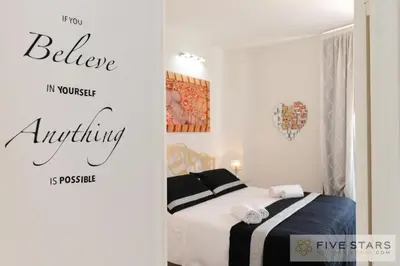 a bedroom with a bed and a sign that says believe my worst anything at Mini Suite Bijou - Five Stars Holiday House in Nice