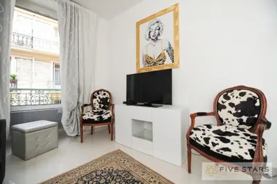 a living room with two chairs and a flat screen tv at Mini Suite Bijou - Five Stars Holiday House in Nice