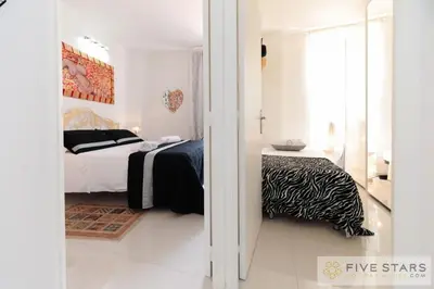 a white bedroom with a bed and a window at Mini Suite Bijou - Five Stars Holiday House in Nice