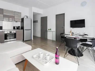 a living room with a white couch and a table at Apartment Le Mozart by Interhome in Nice