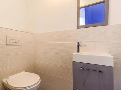 a bathroom with a toilet and a sink at Apartment Le Mozart by Interhome in Nice