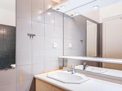 a bathroom with a sink and a mirror at Apartment Le Clos tranquille by Interhome in Nice