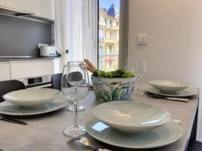 a table with plates and wine glasses on it at Nestor&Jeeves - BLUE OCEAN - Central - Very close beaches in Nice