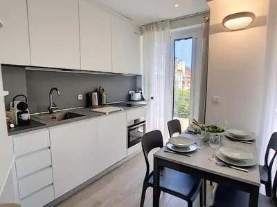 a kitchen and dining room with a table and chairs at Nestor&Jeeves - BLUE OCEAN - Central - Very close beaches in Nice