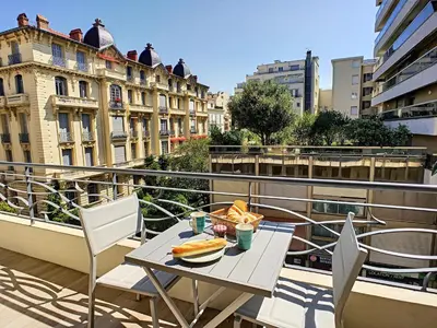a table with a plate of food on a balcony at Nestor&Jeeves - BLUE OCEAN - Central - Very close beaches in Nice
