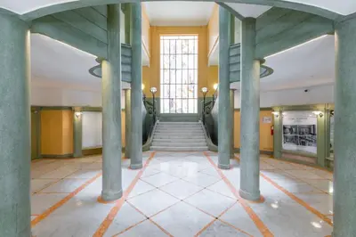 a hallway with columns and stairs in a building at Nestor&Jeeves - SEA VIEW TERRACE PENTHOUSE - Exceptional terrace - Top floor in Nice