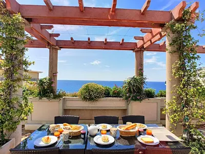 a table with plates of food on a patio at Nestor&Jeeves - SEA VIEW TERRACE PENTHOUSE - Exceptional terrace - Top floor in Nice