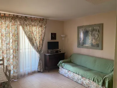 a living room with a couch and a window at Palais des Arts, Proche Tram et Promenade in Nice