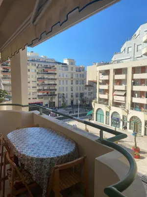 a table on a balcony with a view of the city at Palais des Arts, Proche Tram et Promenade in Nice