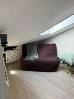 a couch sitting in the middle of a room at Mansarde à 1 min de la mer in Nice