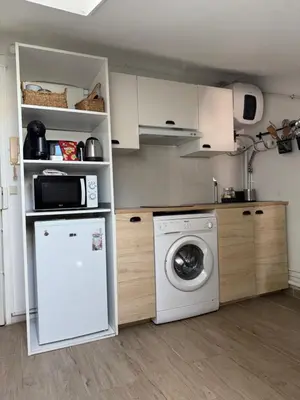 a kitchen with a washing machine and a washer at Mansarde à 1 min de la mer in Nice