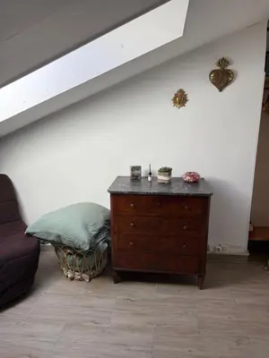 a living room with a dresser and a couch at Mansarde à 1 min de la mer in Nice