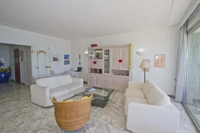 a living room with two white couches and a glass table at PROMENADE HOLIDAY - SEA FRONT PALATIN in Nice