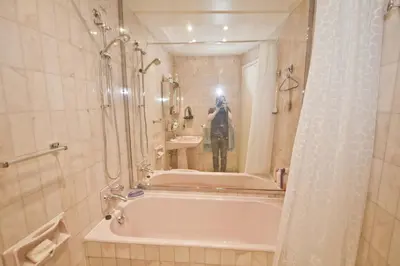 a person taking a picture of a bathroom with a tub at PROMENADE HOLIDAY - SEA FRONT PALATIN in Nice