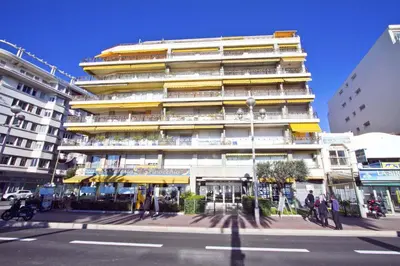 a tall building on a city street with people walking in front of it at PROMENADE HOLIDAY - SEA FRONT PALATIN in Nice